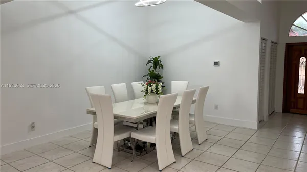 a dining room with furniture and wooden floor