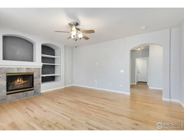 a view of an empty room with a kitchen