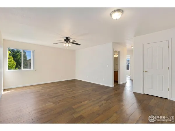 a view of an empty room with wooden floor