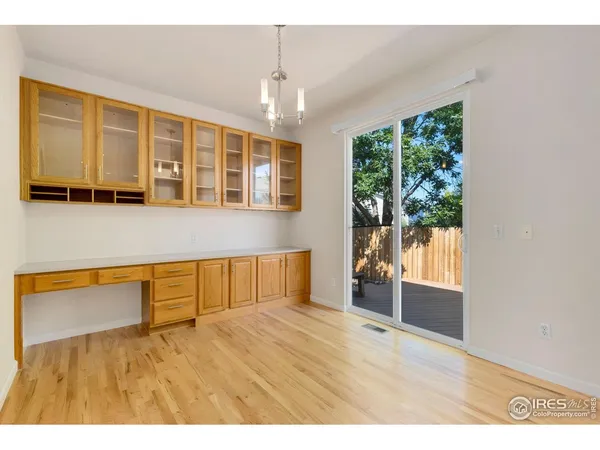 a kitchen with stainless steel appliances granite countertop a refrigerator a sink a stove with wooden cabinets