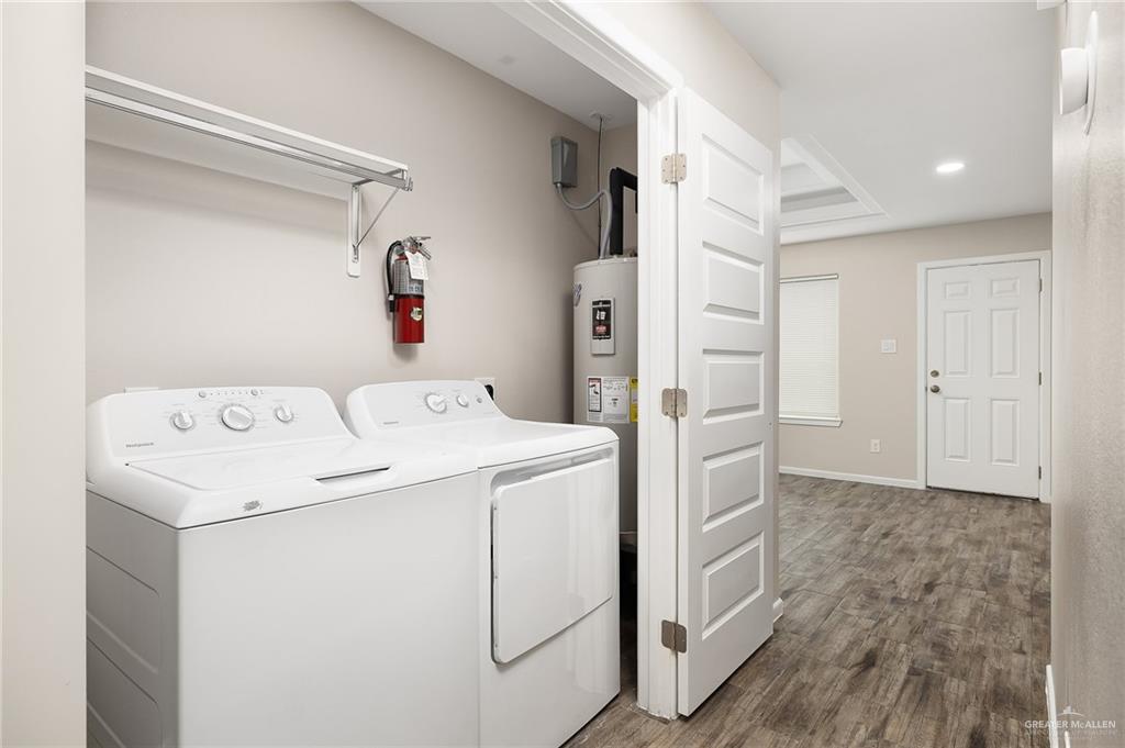 1305 Alta Vista Drive, Unit 4 Weslaco, TX 78596 - Photo 6 of 13 Laundry area featuring wood finished floors, washing machine and dryer, and recessed lighting