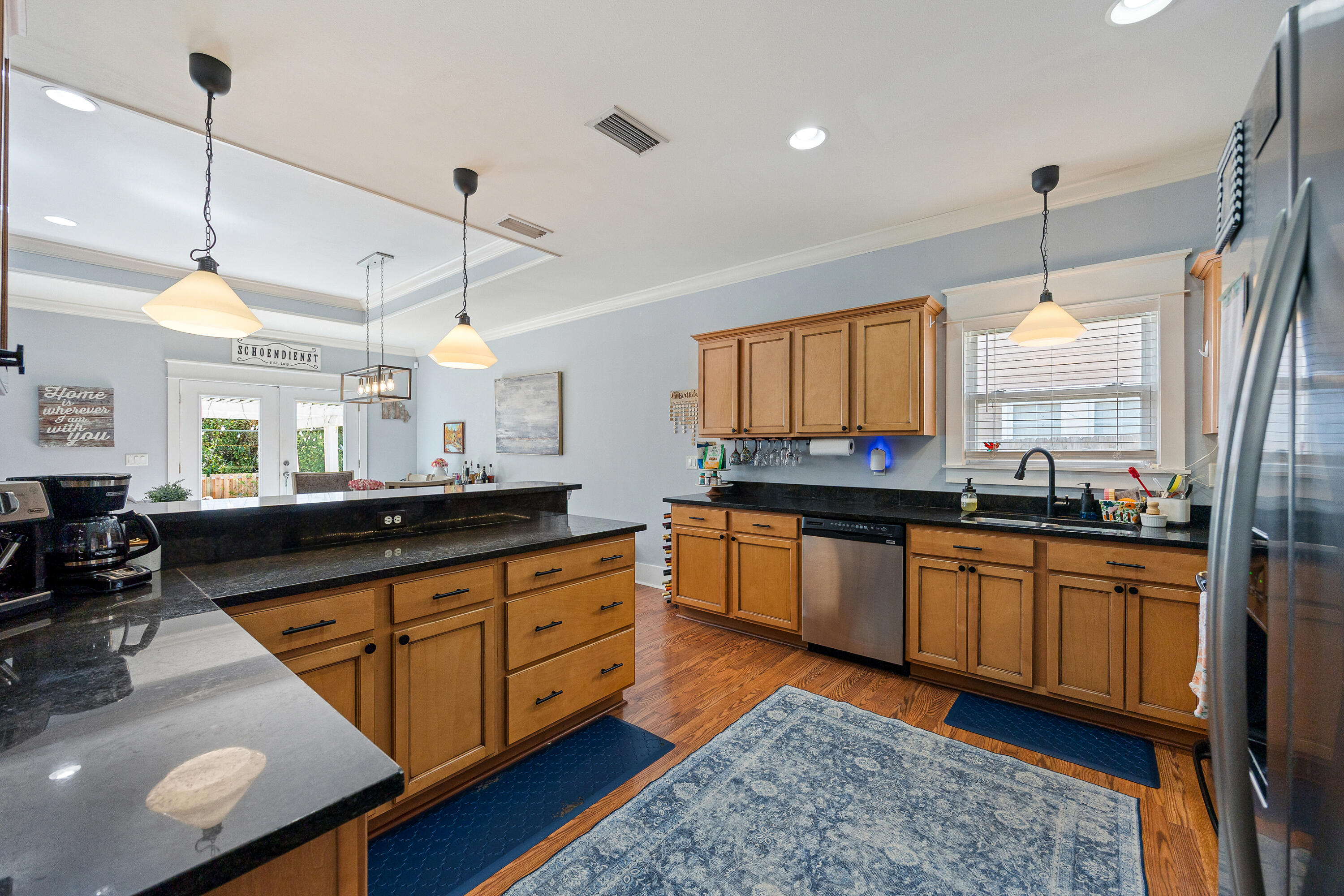 804 Symphony Way Freeport, FL 32439 - Photo 11 of 34 a large kitchen with kitchen island granite countertop a sink a counter space appliances and a window