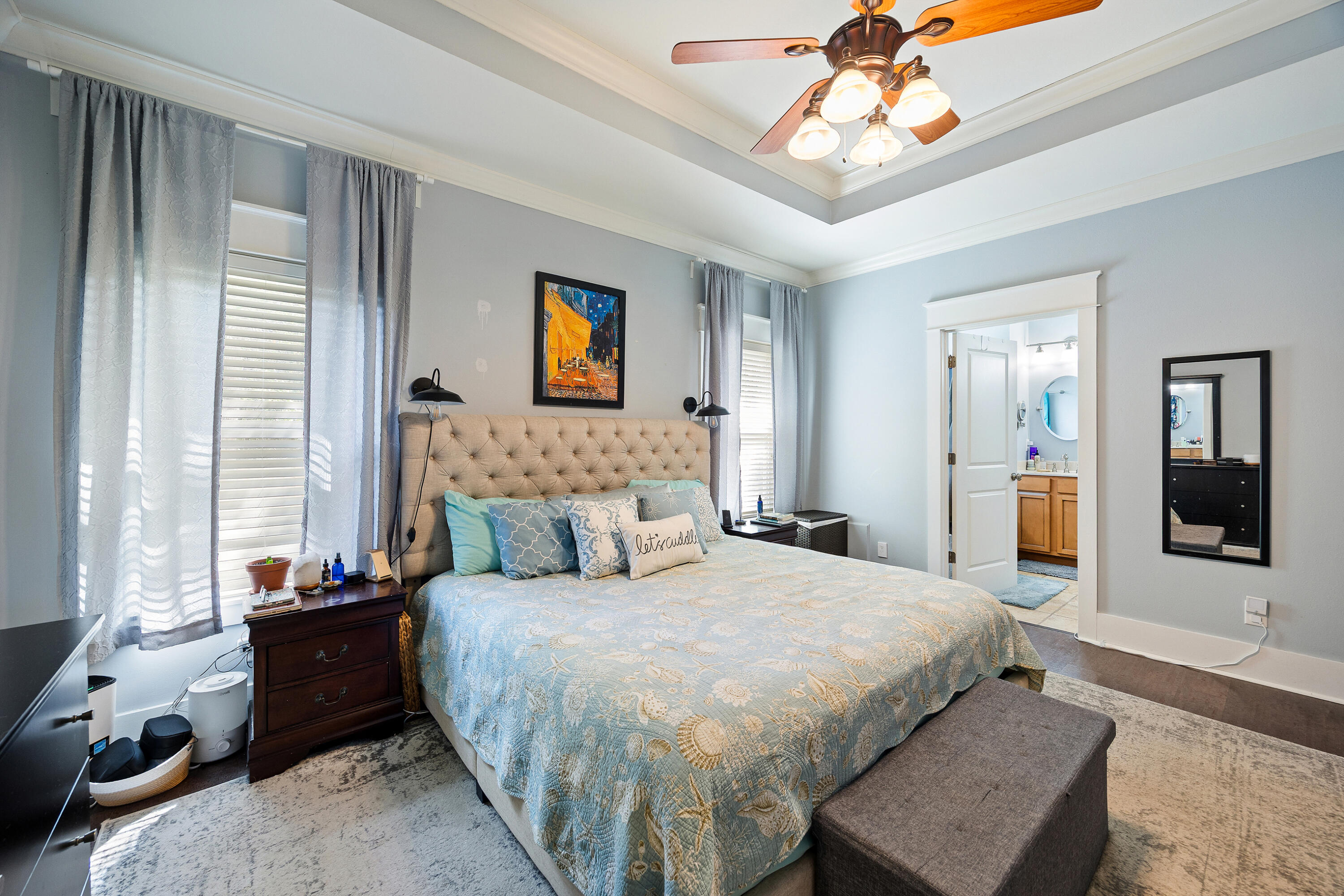 804 Symphony Way Freeport, FL 32439 - Photo 16 of 34 a bedroom with a bed and a chandelier