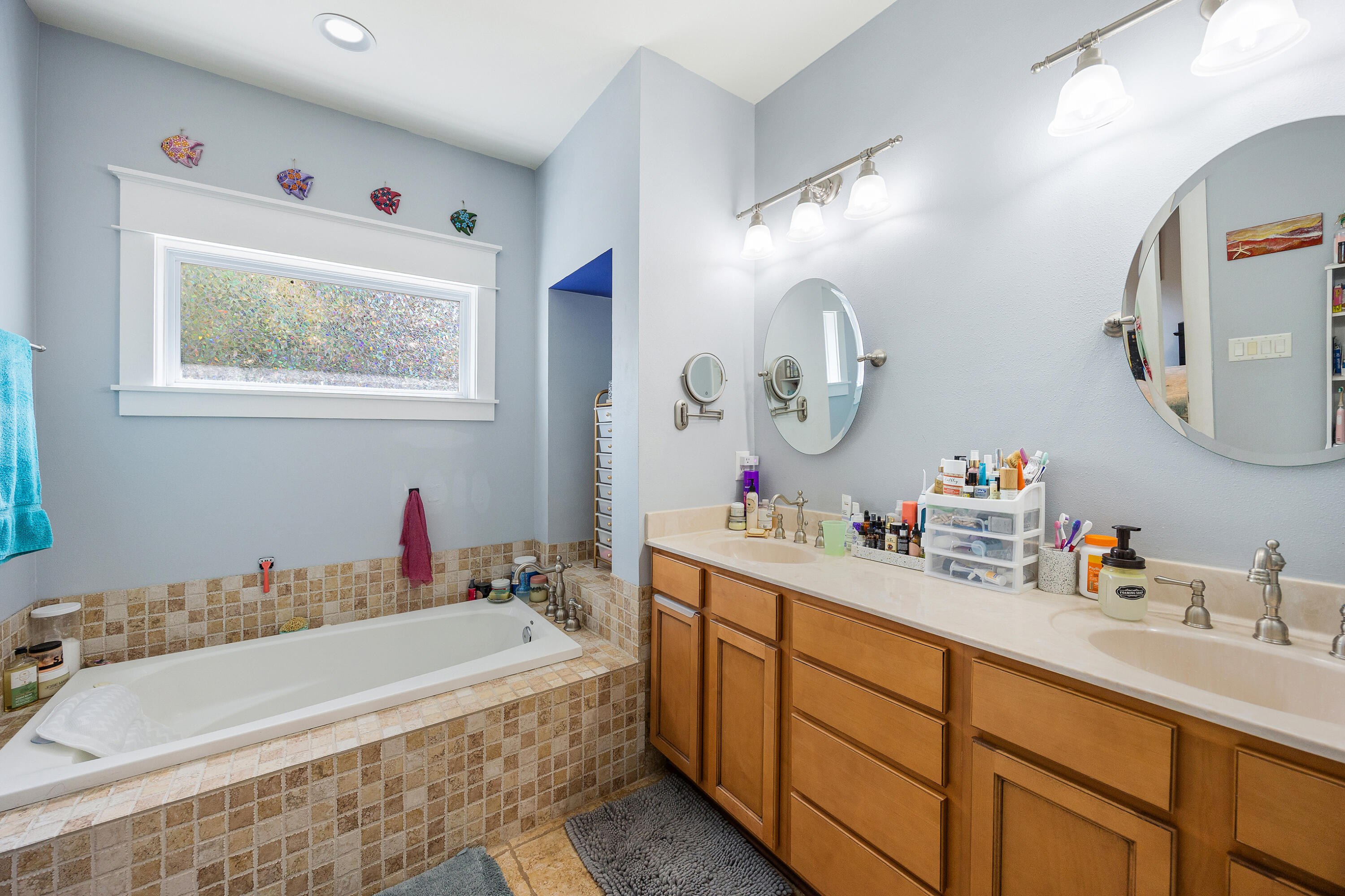 804 Symphony Way Freeport, FL 32439 - Photo 18 of 34 a bathroom with a tub sink and mirror