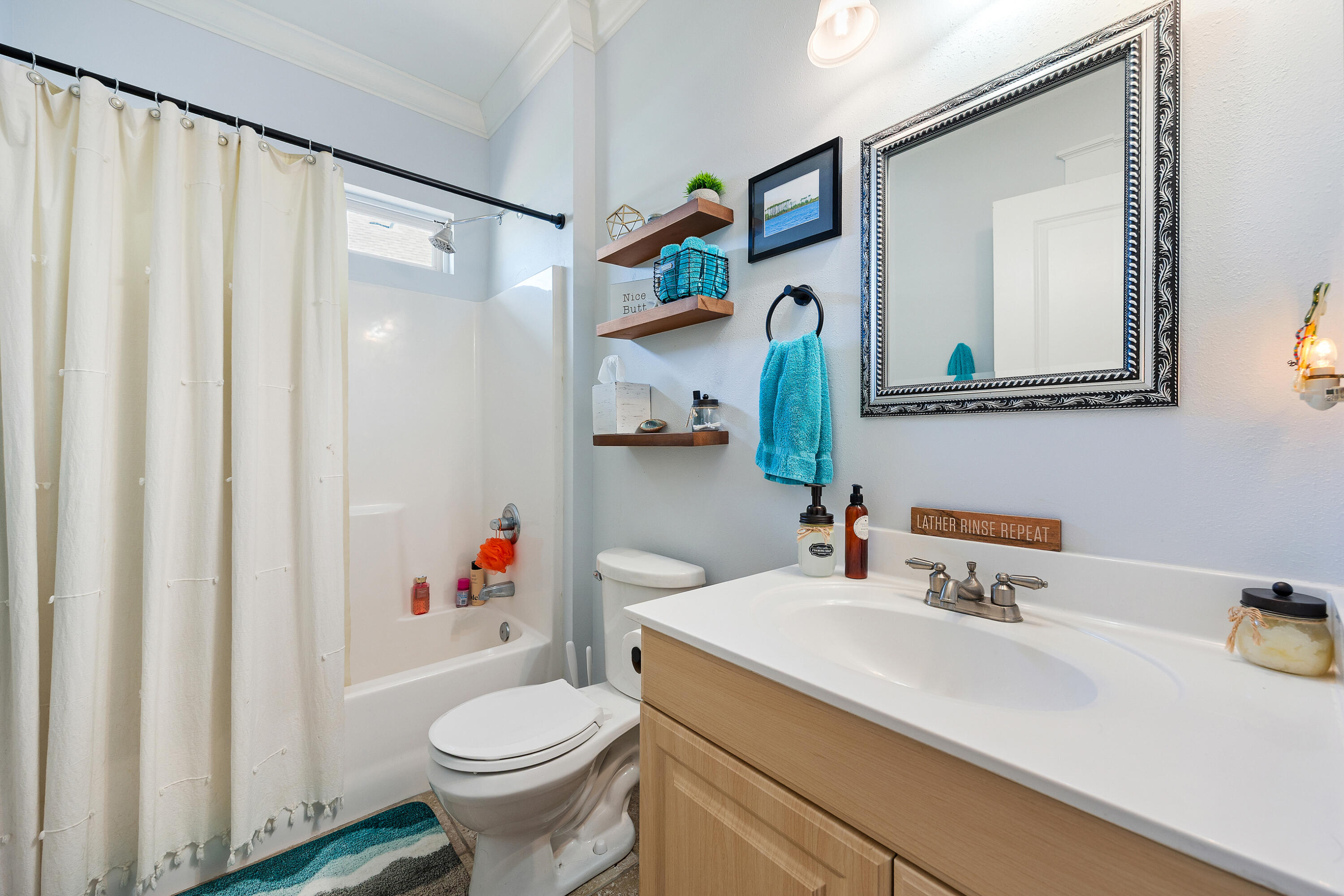 804 Symphony Way Freeport, FL 32439 - Photo 22 of 34 a bathroom with a sink toilet and shower