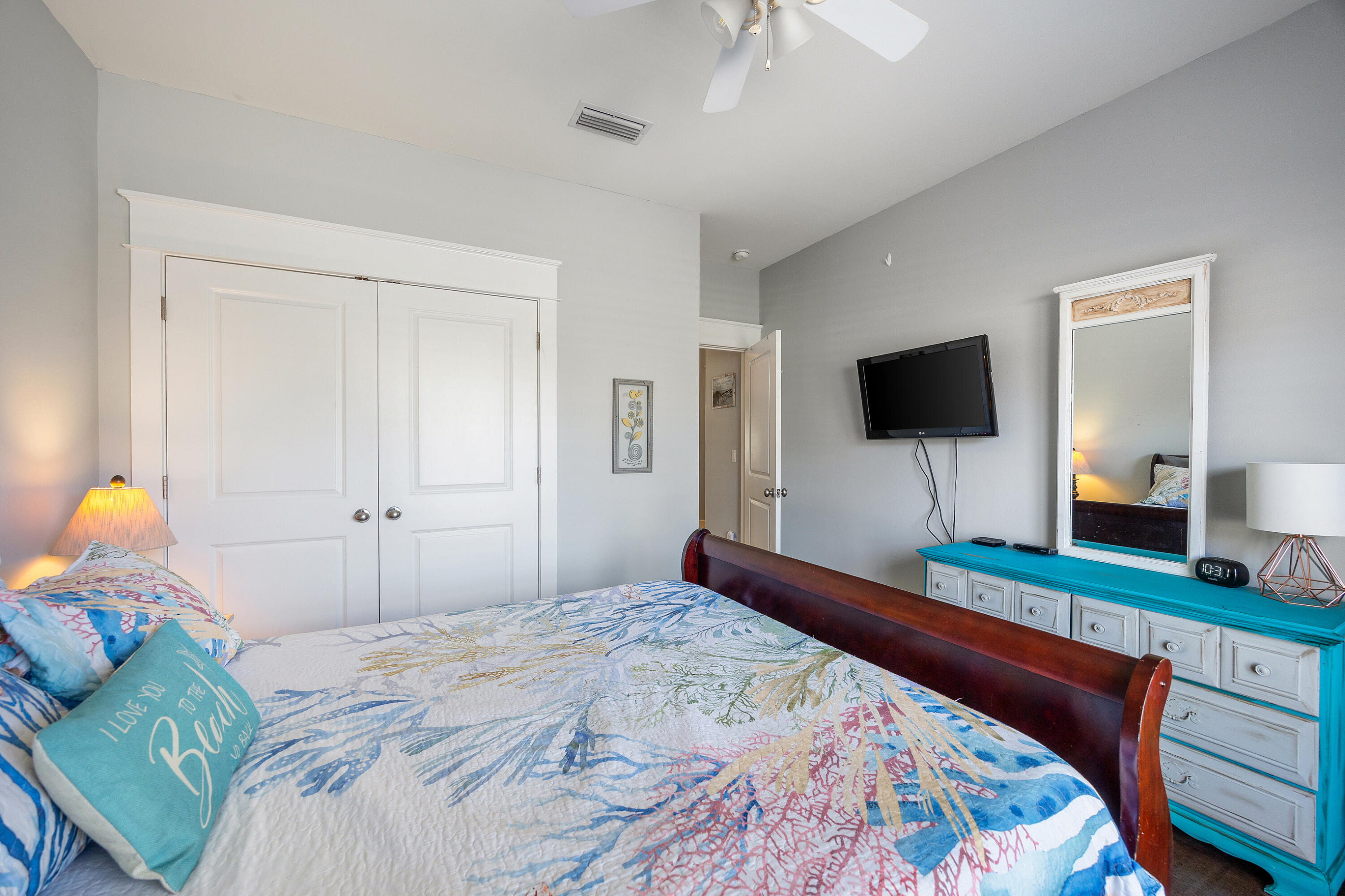 804 Symphony Way Freeport, FL 32439 - Photo 24 of 34 a bedroom with a bed and a flat screen tv