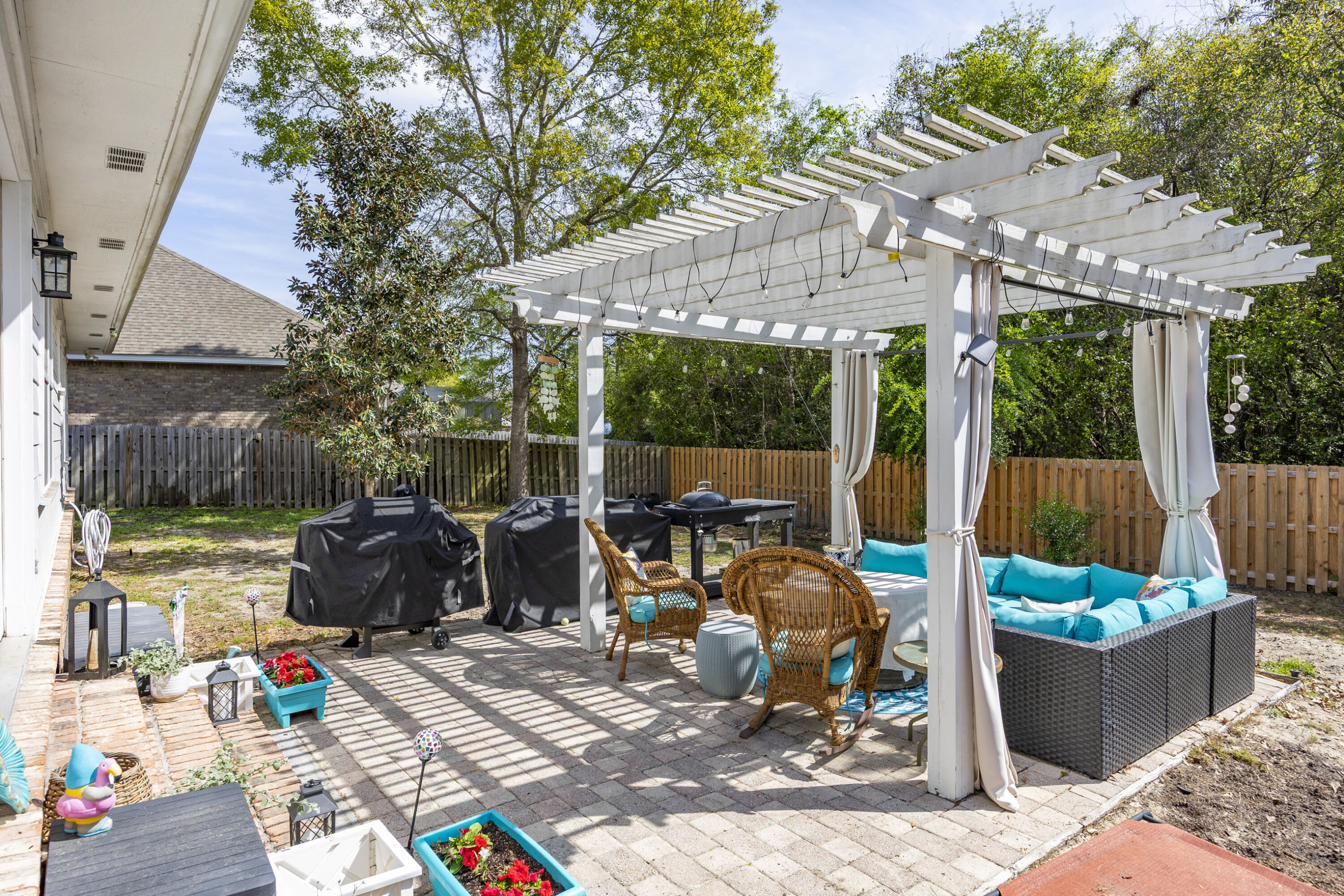 804 Symphony Way Freeport, FL 32439 - Photo 27 of 34 a view of a patio with table and chairs potted plants