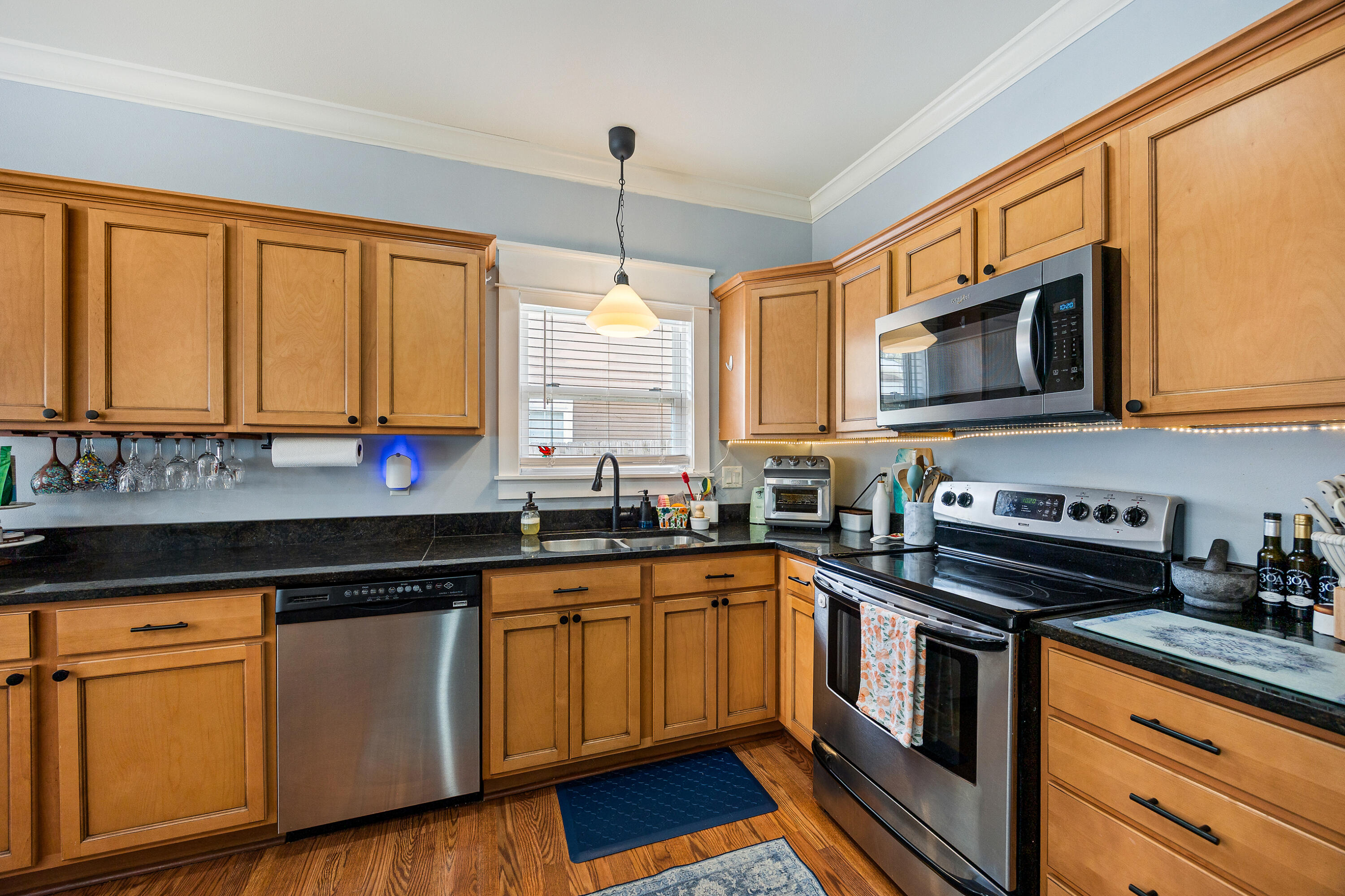 804 Symphony Way Freeport, FL 32439 - Photo 9 of 34 a kitchen with stainless steel appliances granite countertop a stove a sink and a microwave