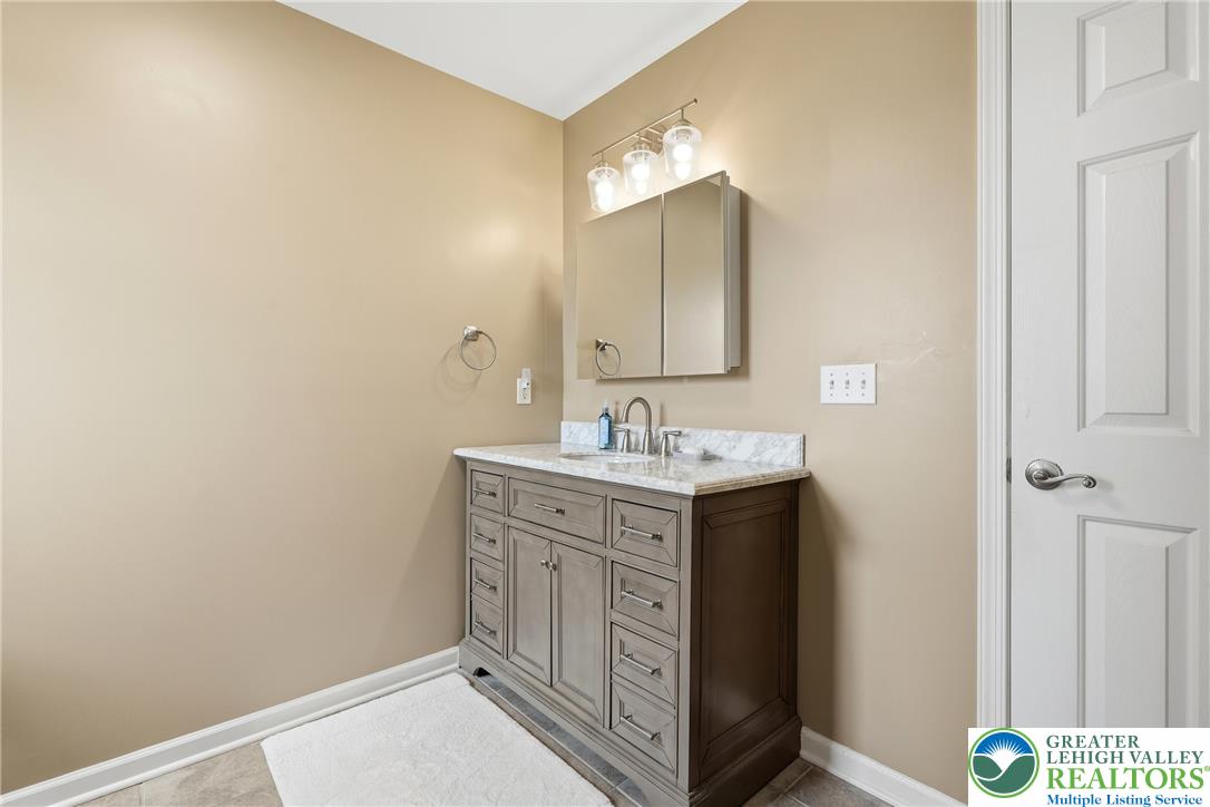 245 East Dell Road Bath, PA 18014 - Photo 51 of 99 A well-appointed vanity with a marble countertop enhances this pristine bathroom's appeal.