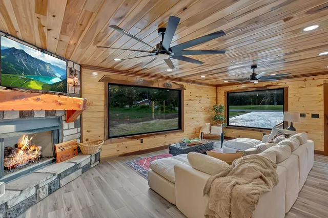 a living room with fireplace furniture and a flat screen tv