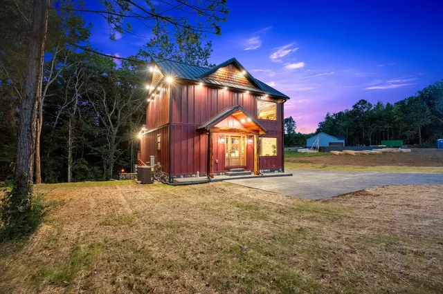 a view of a house with a yard and a garage