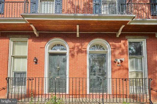 a view of a brick house with a large door
