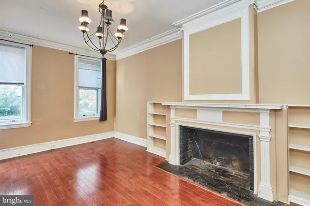a view of a livingroom with a fireplace and window