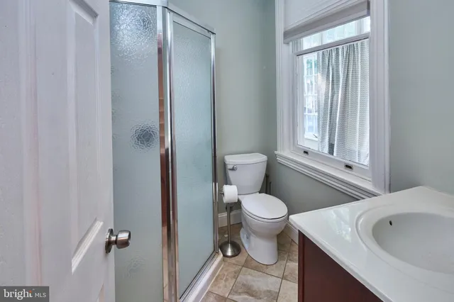 a white toilet sitting next to a bathroom sink