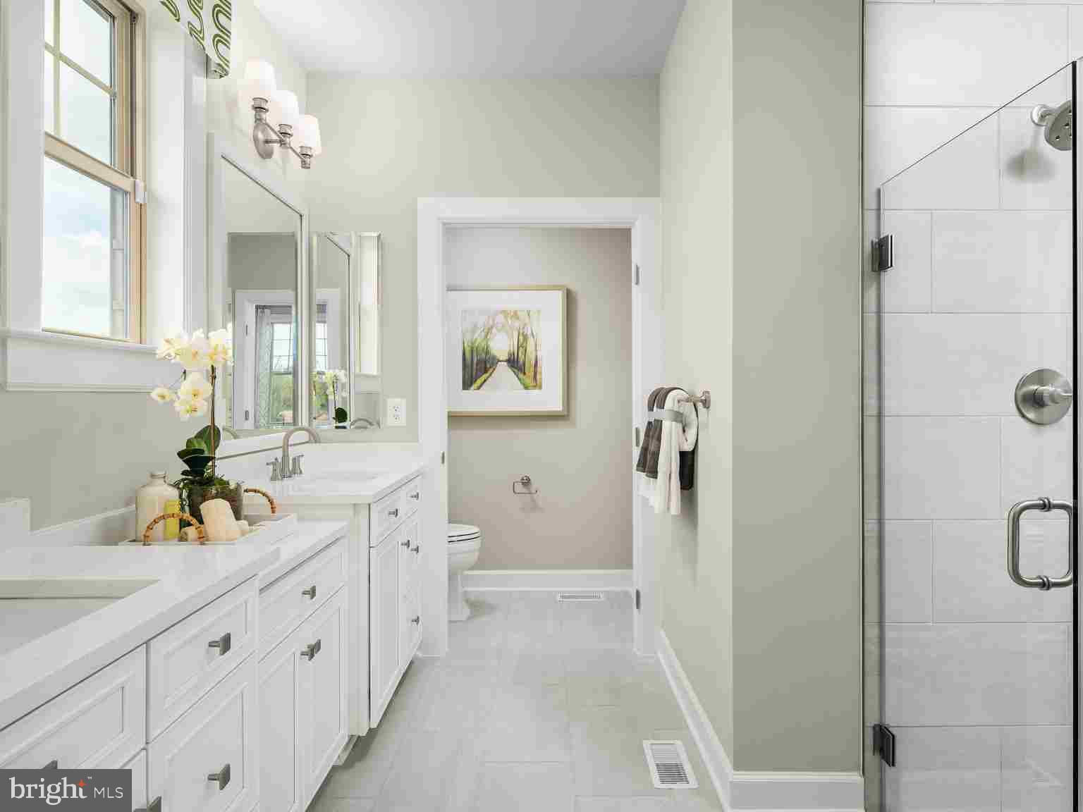 6558 Stream Song Court Columbia, MD 21044 - Photo 12 of 20 a spacious bathroom with a double vanity sink a mirror a shower and a bathtub