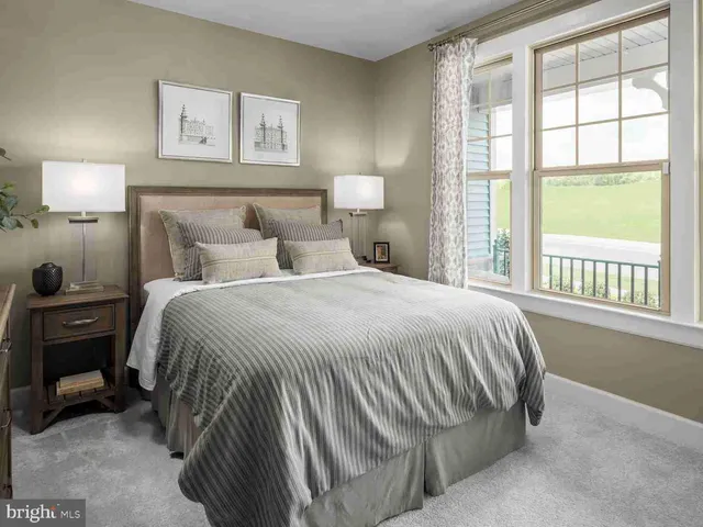 a bedroom with a bed and a lamp next to a window