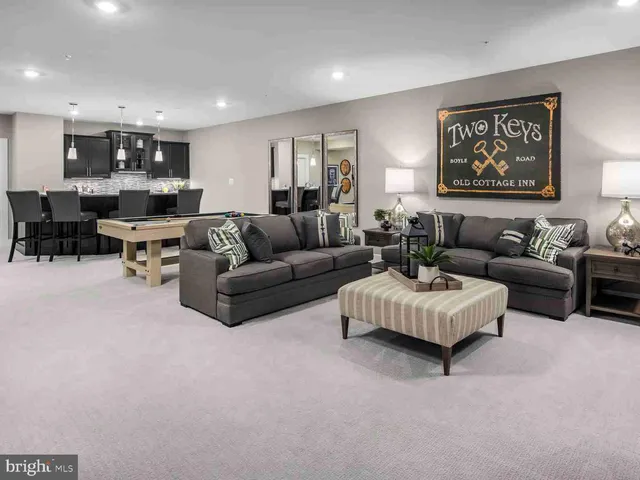 a living room with furniture and kitchen view