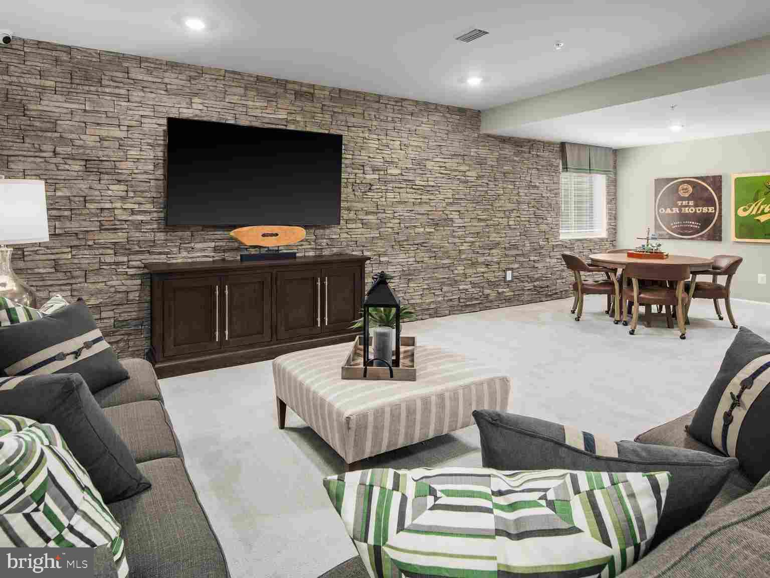 6558 Stream Song Court Columbia, MD 21044 - Photo 18 of 20 a living room with furniture a flat screen tv and a fireplace