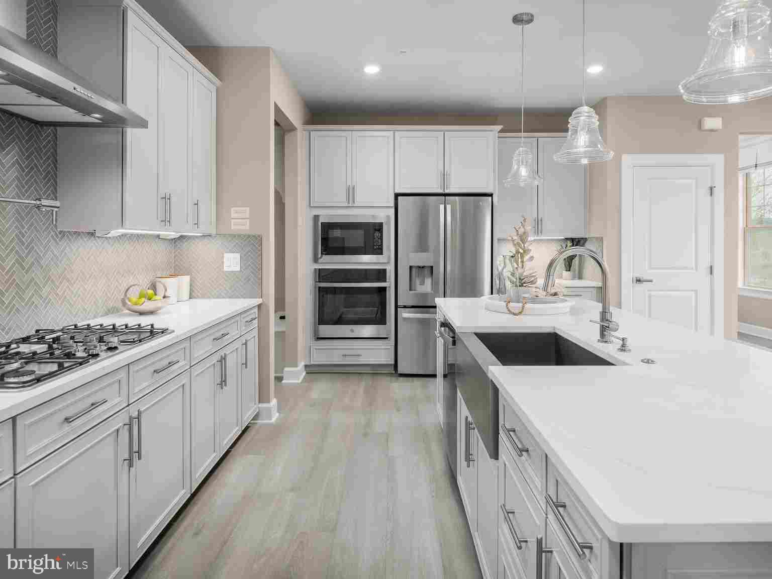 6558 Stream Song Court Columbia, MD 21044 - Photo 8 of 20 a kitchen with kitchen island a sink stove and refrigerator