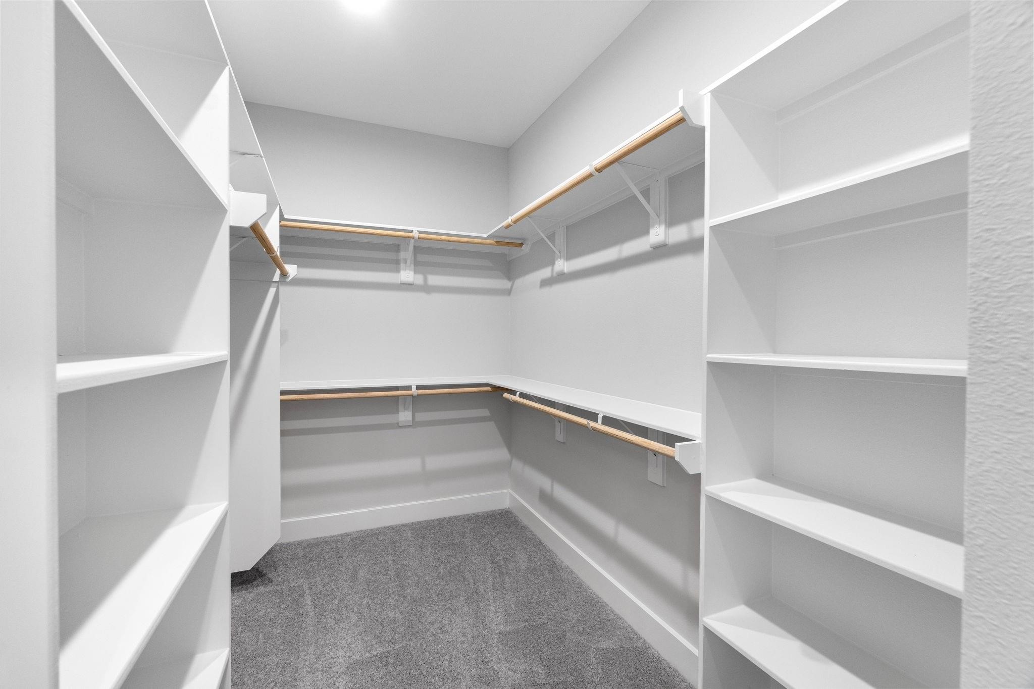 903 Quitman Street, Unit B Houston, TX 77009 - Photo 13 of 23 Generously sized walk-in closet with built-in shelving and hanging space, thoughtfully designed for optimal organization.