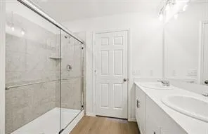 a spacious bathroom with a shower and a sink