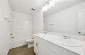 a bathroom with a sink toilet tub and shower
