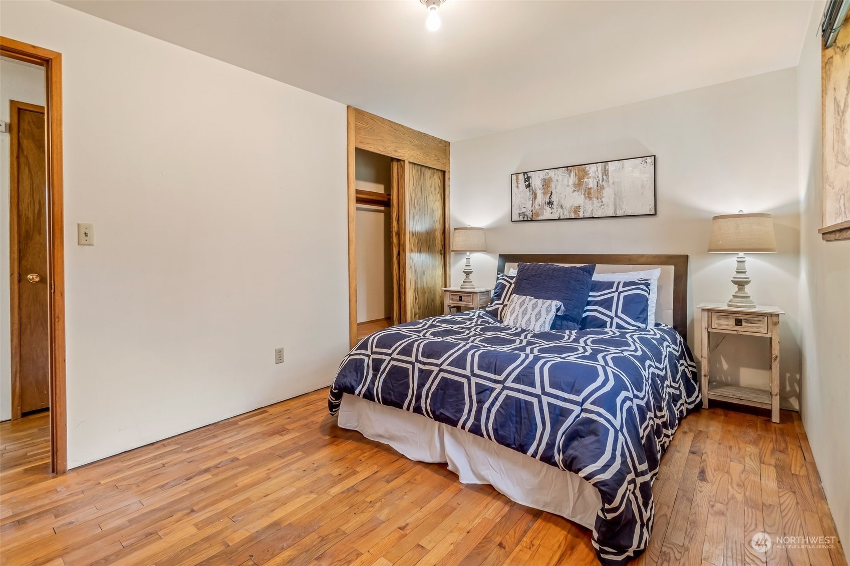 24204 2nd Place West Bothell, WA 98021 - Photo 17 of 34 a bedroom with a bed and wooden floor