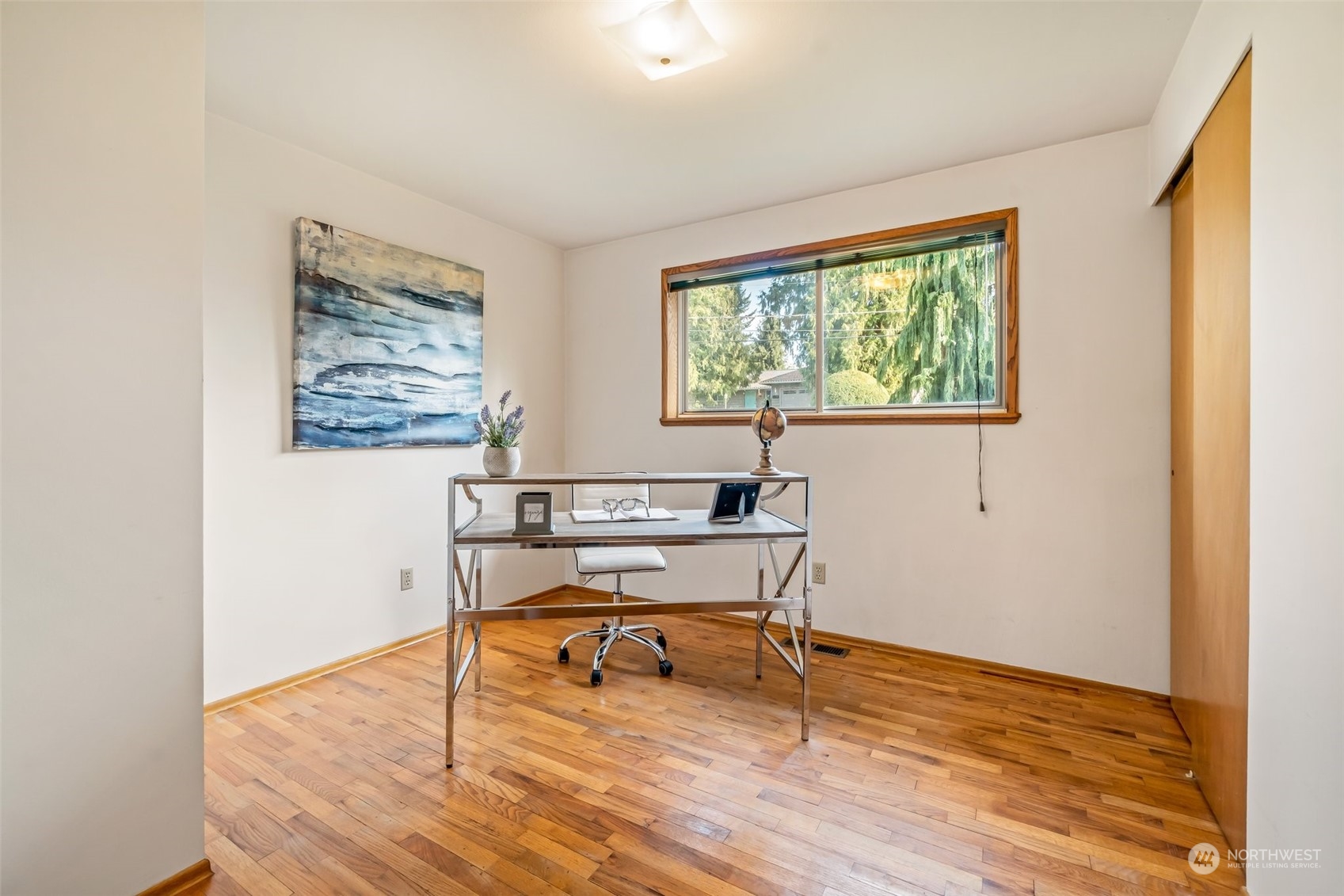 24204 2nd Place West Bothell, WA 98021 - Photo 19 of 34 a view of a livingroom with wooden floor and a bookshelf