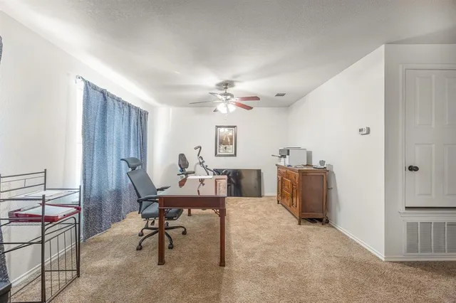 a view of a livingroom with furniture and a window
