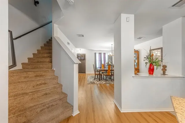 a view of entryway and hall with wooden floor