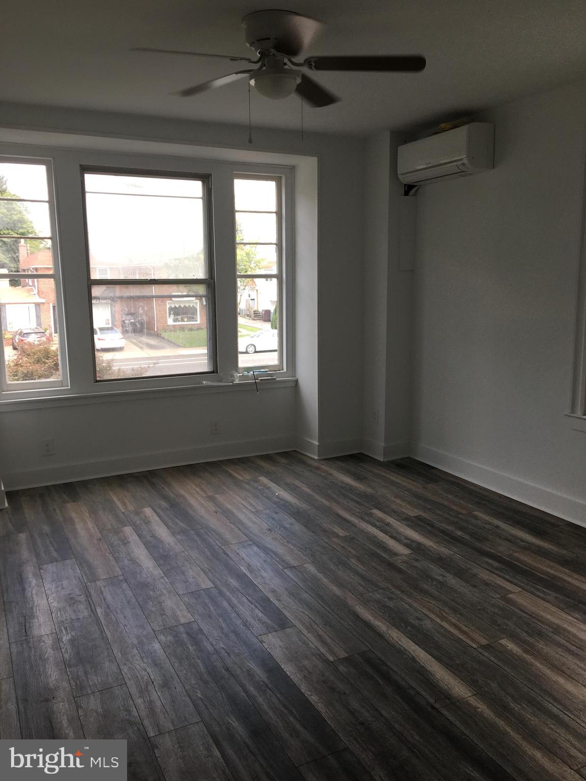 1908 Darby Road, Unit 2 Havertown, PA 19083 - Photo 2 of 14 an empty room with wooden floor and windows