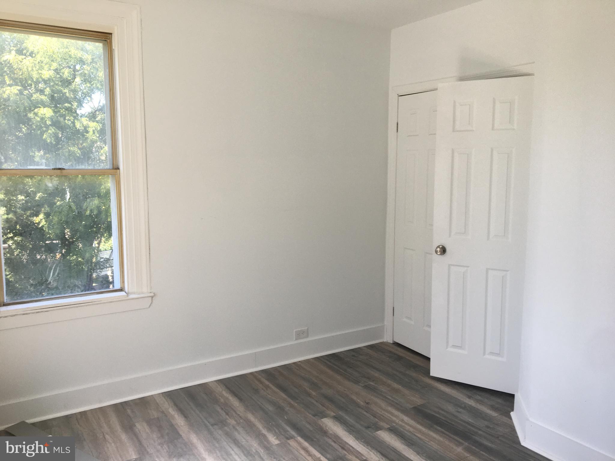 1908 Darby Road, Unit 2 Havertown, PA 19083 - Photo 8 of 14 an empty room with wooden floor and windows
