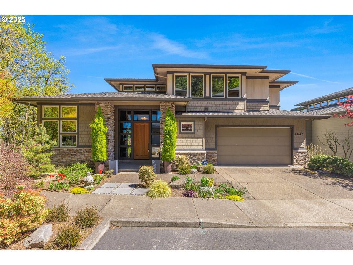 6643 Northwest Meridian Ridge Drive Portland, OR 97210 - Photo 1 of 48 a front view of a house with a yard and a garage