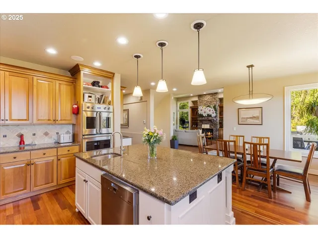 a kitchen with center island table and chairs