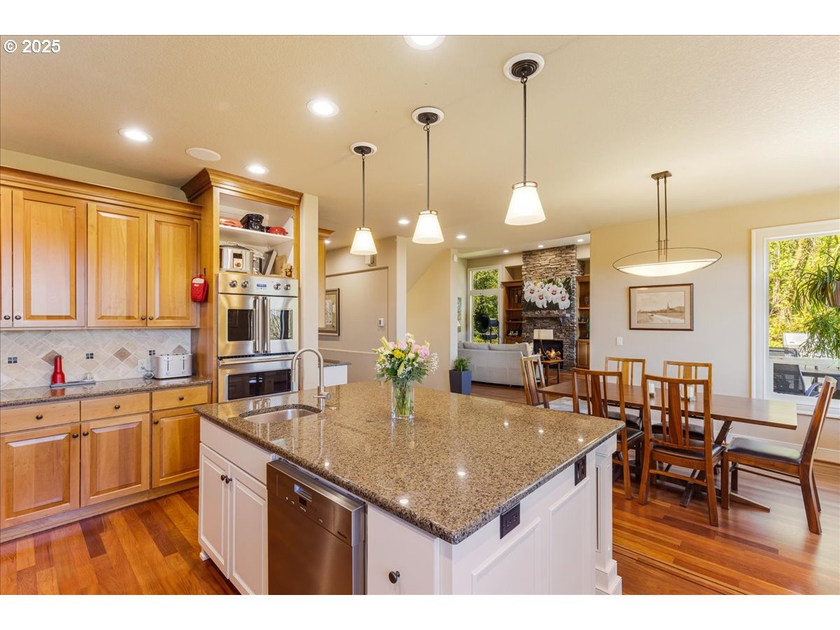 6643 Northwest Meridian Ridge Drive Portland, OR 97210 - Photo 12 of 48 a kitchen with center island table and chairs