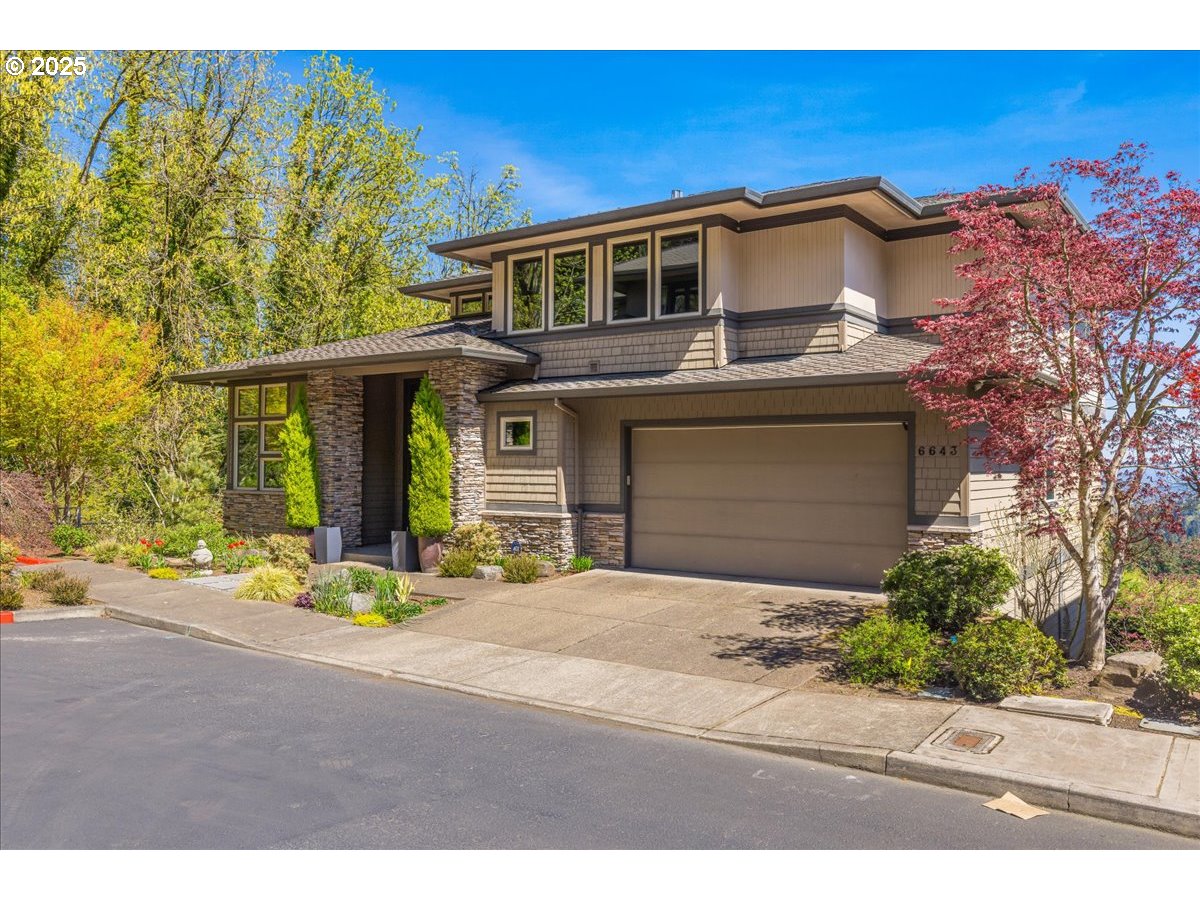6643 Northwest Meridian Ridge Drive Portland, OR 97210 - Photo 2 of 48 a front view of a house with a garage