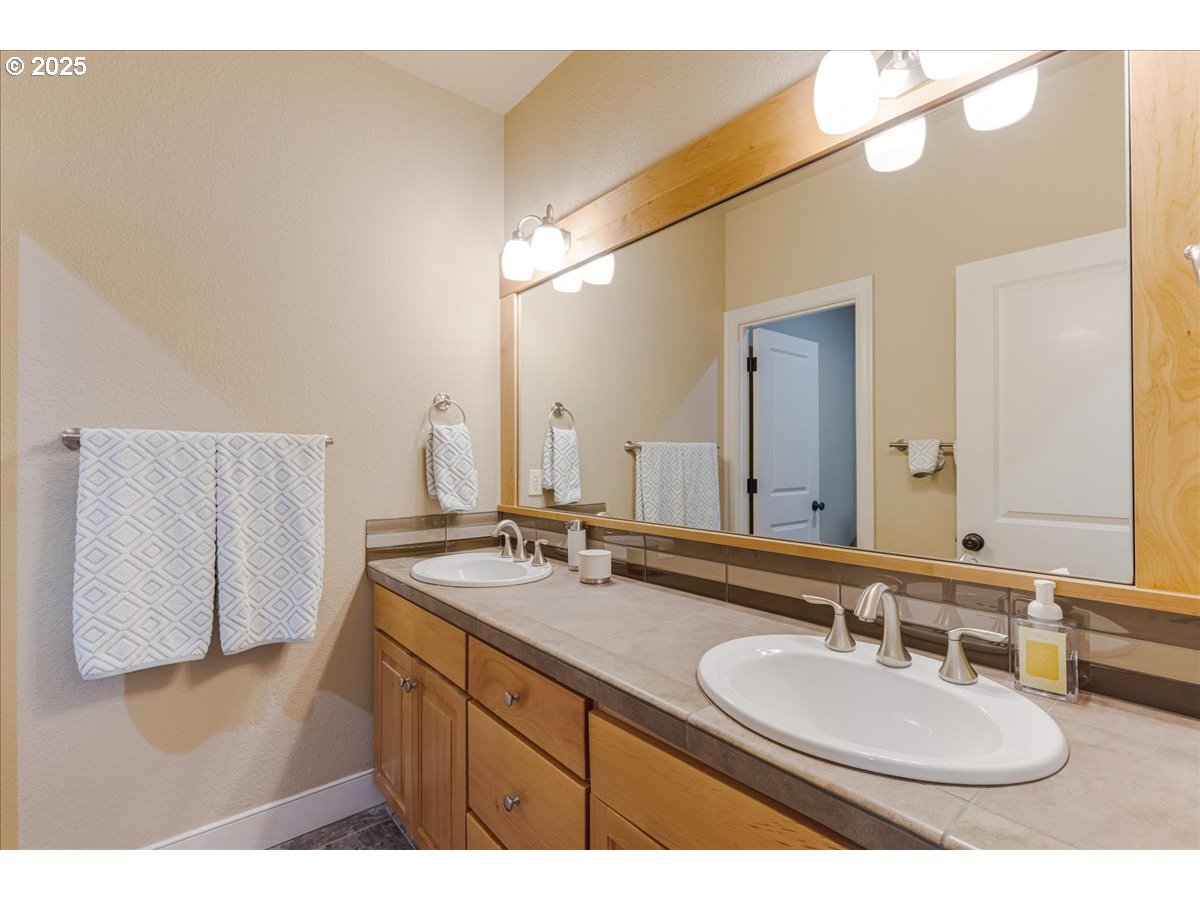 6643 Northwest Meridian Ridge Drive Portland, OR 97210 - Photo 23 of 48 a bathroom with a sink and a mirror
