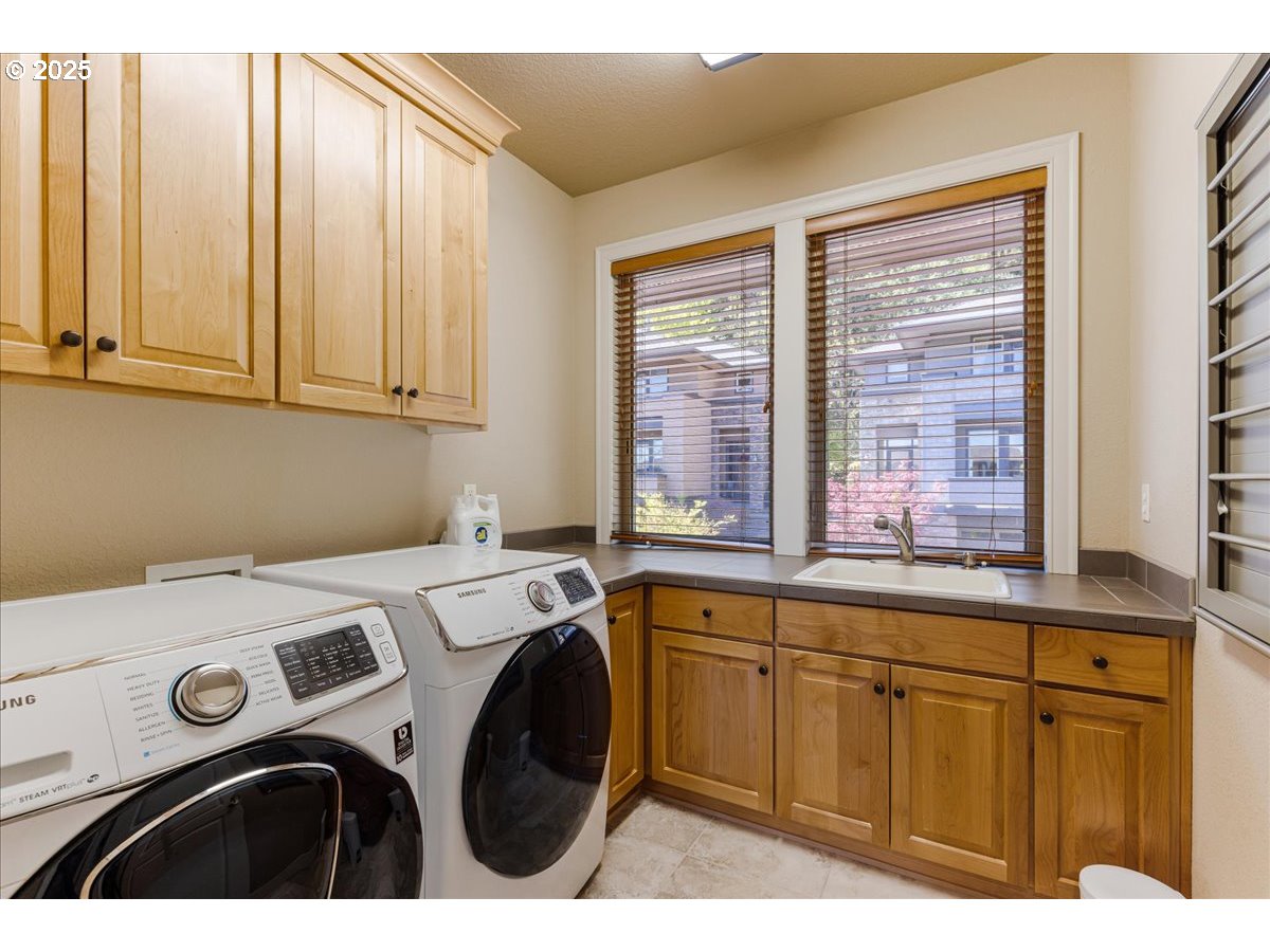 6643 Northwest Meridian Ridge Drive Portland, OR 97210 - Photo 24 of 48 a utility room with dryer and washer