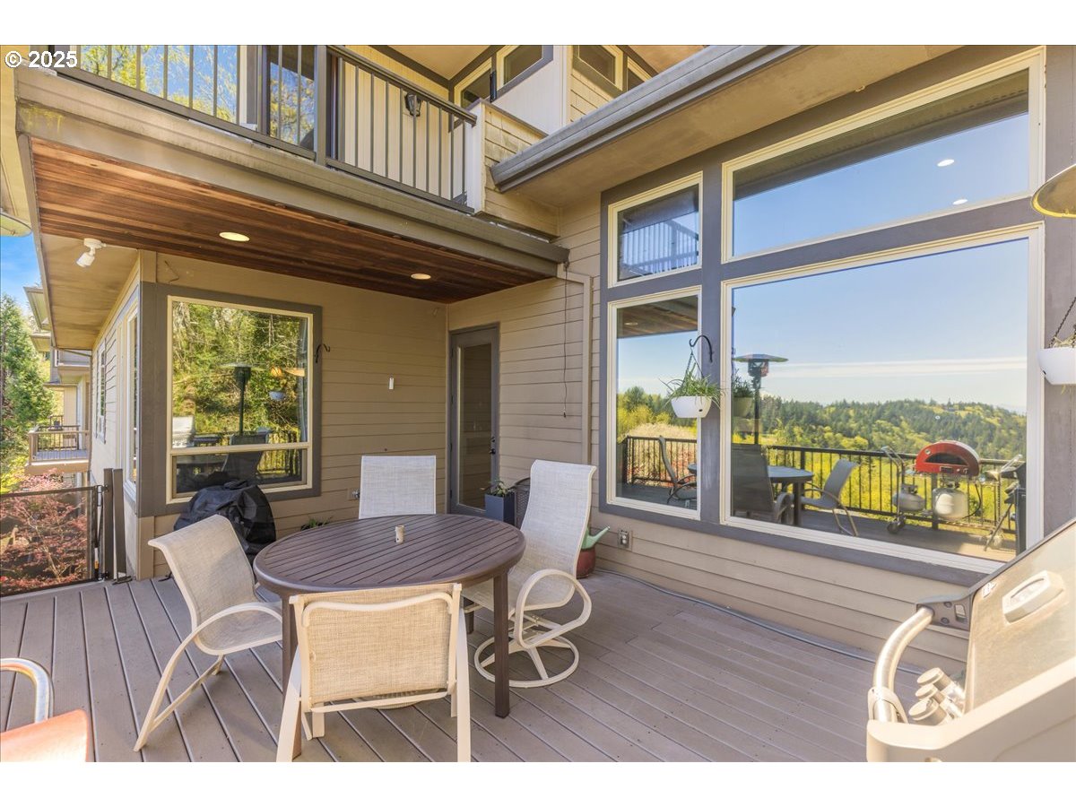 6643 Northwest Meridian Ridge Drive Portland, OR 97210 - Photo 38 of 48 a dining room with furniture large windows and wooden floor
