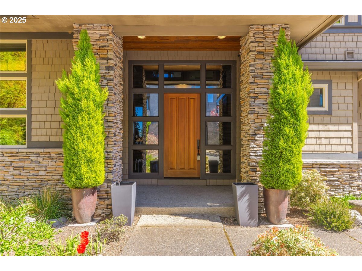 6643 Northwest Meridian Ridge Drive Portland, OR 97210 - Photo 4 of 48 a front view of a house with garden