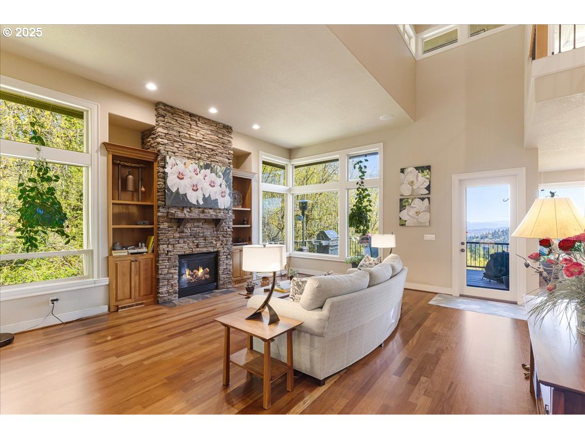 6643 Northwest Meridian Ridge Drive Portland, OR 97210 - Photo 5 of 48 a living room with furniture a fireplace and a large window
