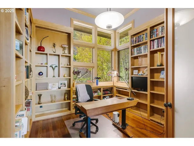 a living room with furniture a rug and a book shelf
