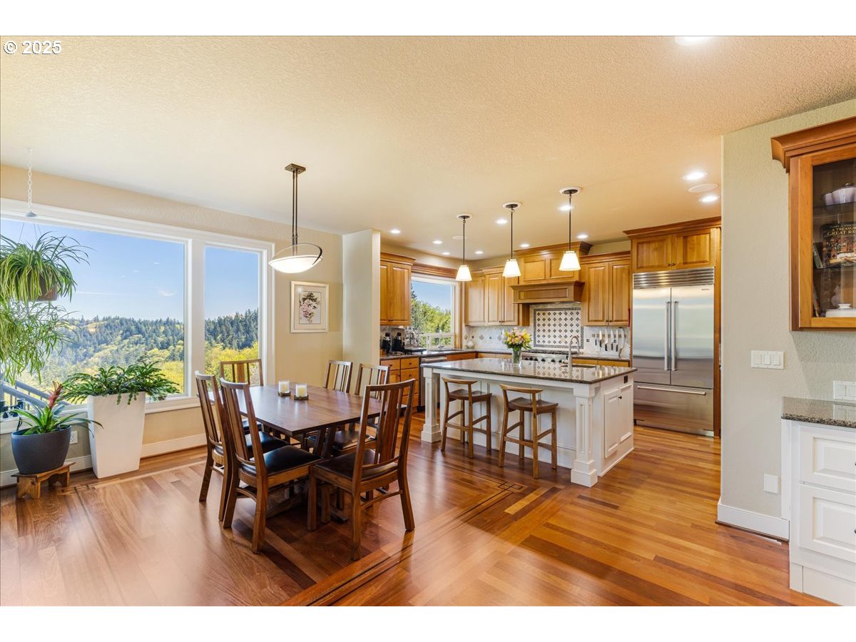 6643 Northwest Meridian Ridge Drive Portland, OR 97210 - Photo 9 of 48 a large kitchen with a table and chairs
