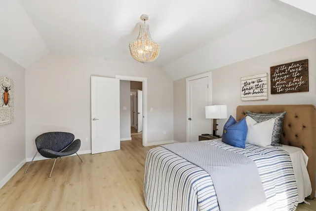 a bedroom with a bed and a chair