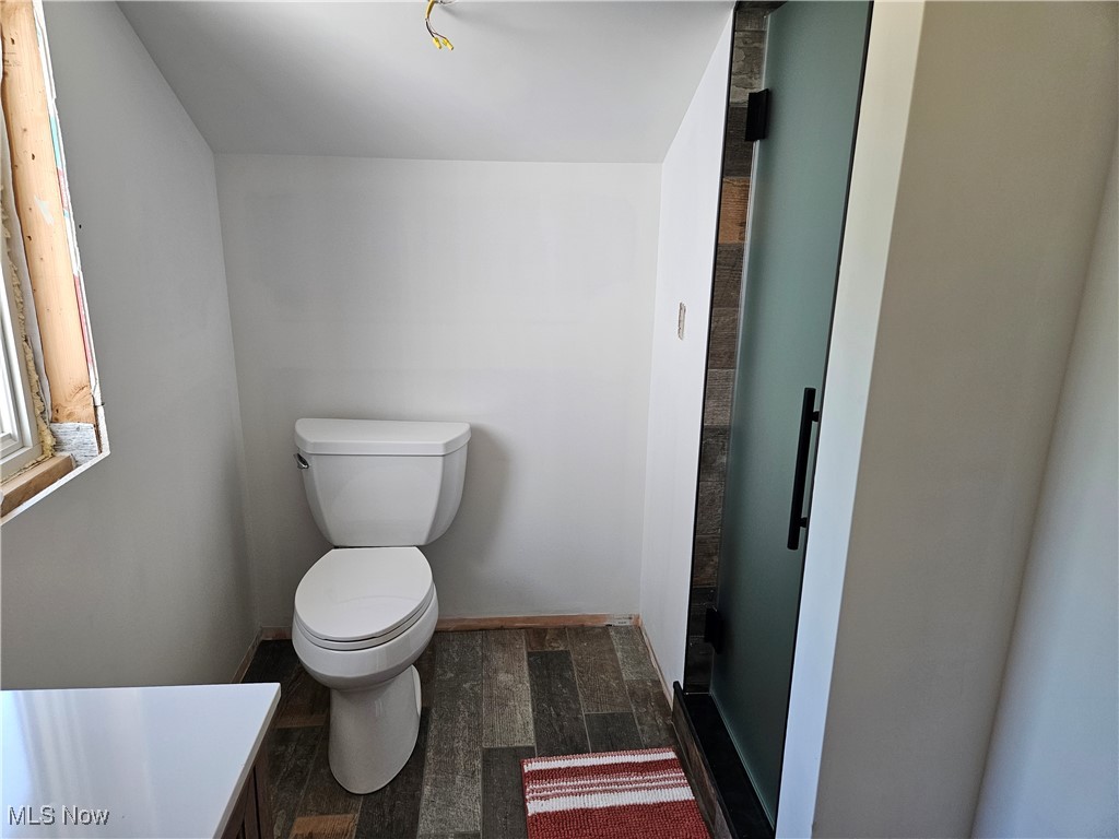 1180 North County Line Road Geneva, OH 44041 - Photo 32 of 33 upstairs Bathroom with wood finished floors and toilet