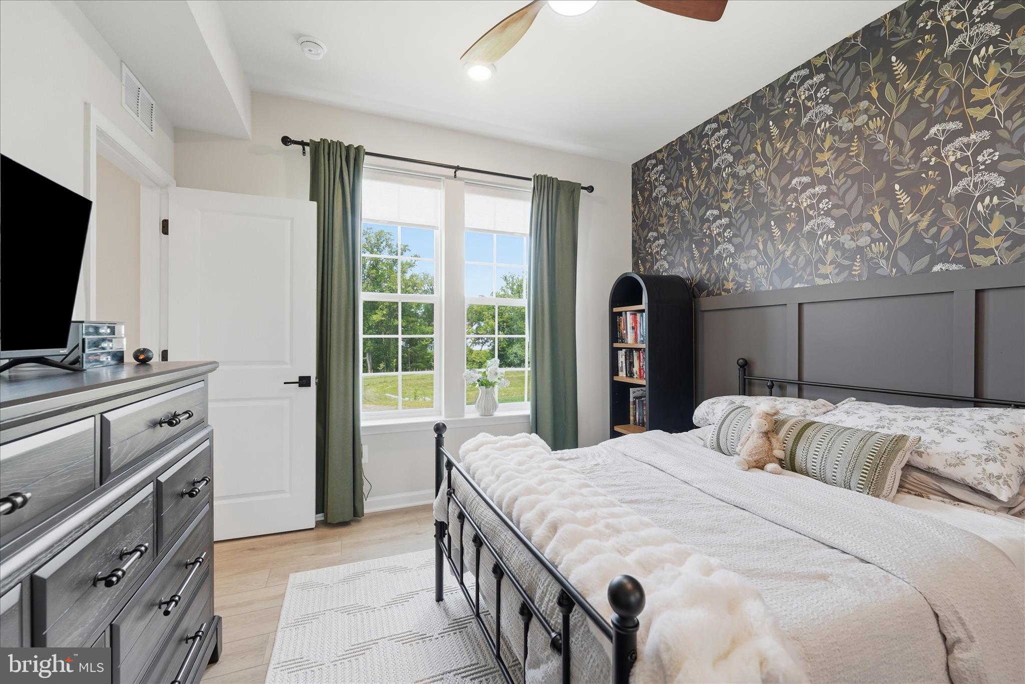 910 Enfield Farm Lane Brunswick, MD 21716 - Photo 27 of 87 a bedroom with a bed and a flat screen tv