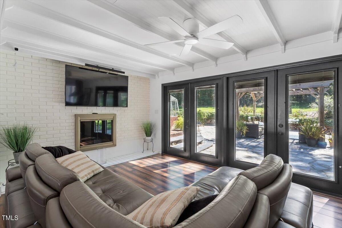 2129 Kelly Road Apex, NC 27502 - Photo 10 of 64 a bedroom with furniture a flat screen tv and a fireplace