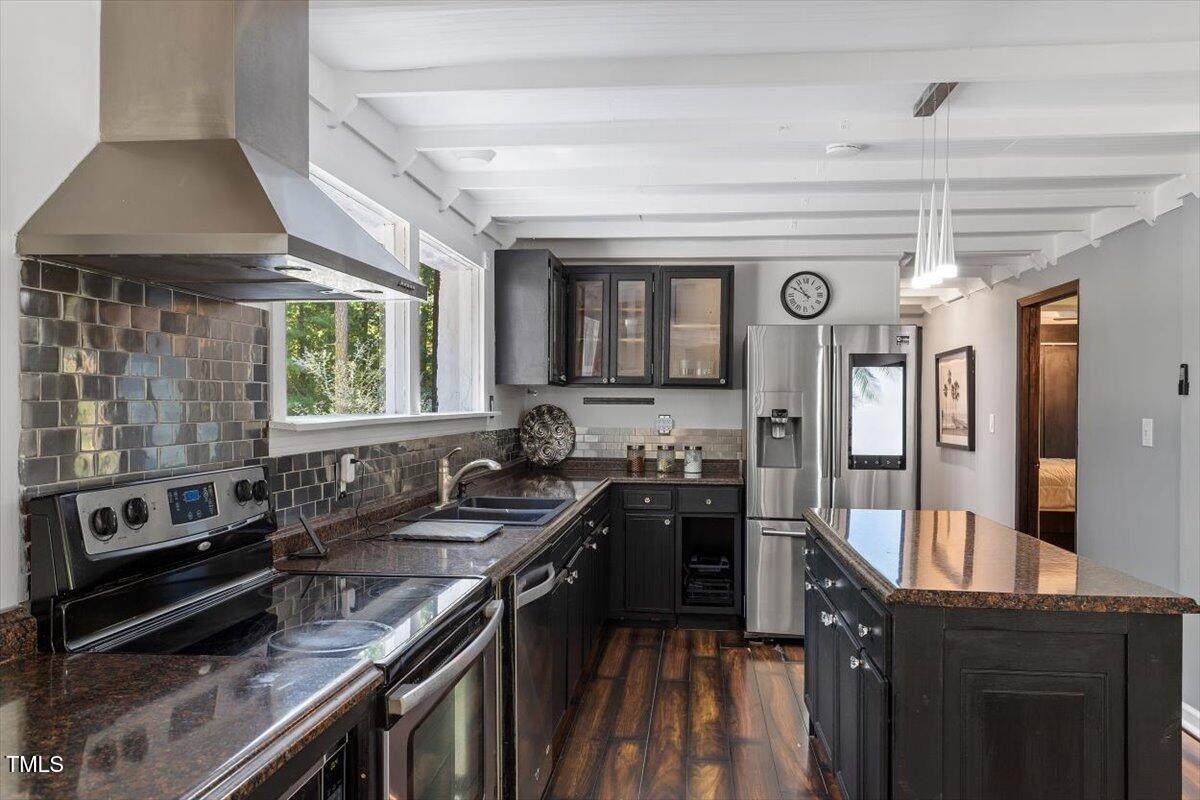 2129 Kelly Road Apex, NC 27502 - Photo 15 of 64 a kitchen with stainless steel appliances granite countertop a sink stove and cabinets