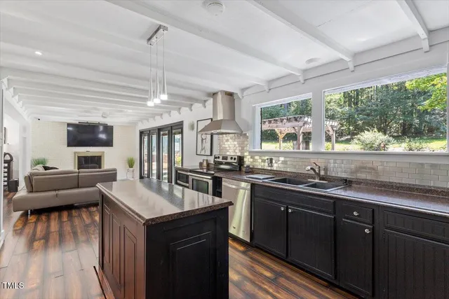 a bathroom with a sink a mirror and a window