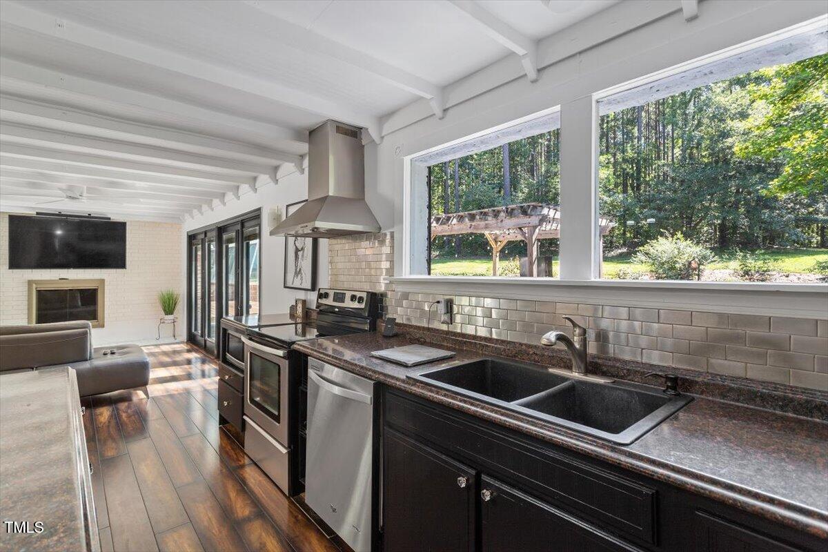 2129 Kelly Road Apex, NC 27502 - Photo 18 of 64 a kitchen that has a sink and a stove